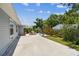 Long view of backyard and patio area that offers space and a lovely view of the landscaping and lawn at 2692 Cedarbrooke Dr, Palm Harbor, FL 34684