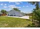 Spacious backyard with a well-manicured lawn and a concrete patio, perfect for Gathering gatherings and outdoor activities at 2692 Cedarbrooke Dr, Palm Harbor, FL 34684
