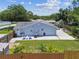 Spacious, fenced backyard featuring a concrete patio, seating and grilling area, offering outdoor enjoyment at 2692 Cedarbrooke Dr, Palm Harbor, FL 34684
