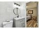 Neat bathroom with white tile walls and a vanity at 2692 Cedarbrooke Dr, Palm Harbor, FL 34684