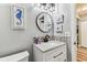 Charming bathroom with decorative nautical themed pictures and accent lighting at 2692 Cedarbrooke Dr, Palm Harbor, FL 34684