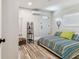 Guest bedroom with wood-look flooring, a comfortable bed, and access to an exit door at 2692 Cedarbrooke Dr, Palm Harbor, FL 34684
