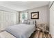 Well-lit bedroom showcasing a comfortable bed, closet, and stylish decor at 2692 Cedarbrooke Dr, Palm Harbor, FL 34684