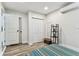 Neat bedroom area with a closet, modern decor, and wood-look flooring at 2692 Cedarbrooke Dr, Palm Harbor, FL 34684