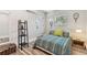 Clean bedroom featuring wood-look floors, a comfortable bed, natural light, and exit access at 2692 Cedarbrooke Dr, Palm Harbor, FL 34684