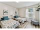 Bright bedroom showcasing two twin beds with sea-themed comforters and beachy decor at 2692 Cedarbrooke Dr, Palm Harbor, FL 34684