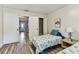 Bedroom with closet and wood-look flooring, showing the entrance to the house at 2692 Cedarbrooke Dr, Palm Harbor, FL 34684