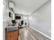 Bonus room featuring an air conditioner, a TV, and wood-look flooring at 2692 Cedarbrooke Dr, Palm Harbor, FL 34684
