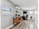 Bonus room with a desk, TV, air conditioner, and a view of the windows at 2692 Cedarbrooke Dr, Palm Harbor, FL 34684