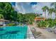 Inviting community pool area with lounge chairs and cabana, providing a relaxing space for residents at 2692 Cedarbrooke Dr, Palm Harbor, FL 34684