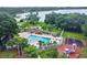 Inviting community pool with a playground area, perfect for Gathering fun and relaxation within the neighborhood at 2692 Cedarbrooke Dr, Palm Harbor, FL 34684