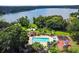 Overhead shot of a community pool and playground nestled near a serene lake, creating a picturesque setting at 2692 Cedarbrooke Dr, Palm Harbor, FL 34684