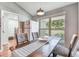 Cozy dining area featuring a long table with bench seating and natural light from a window at 2692 Cedarbrooke Dr, Palm Harbor, FL 34684