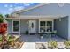 Welcoming front porch with seating and landscaping, enhancing the home's inviting curb appeal at 2692 Cedarbrooke Dr, Palm Harbor, FL 34684