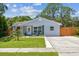 Inviting single-Gathering home featuring a cozy front porch and a neatly landscaped front yard at 2692 Cedarbrooke Dr, Palm Harbor, FL 34684