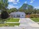 Charming single-story home featuring a well-manicured lawn, inviting entryway and a long driveway at 2692 Cedarbrooke Dr, Palm Harbor, FL 34684