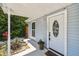 Charming front entrance showing a decorative door and landscaping, enhancing curb appeal at 2692 Cedarbrooke Dr, Palm Harbor, FL 34684