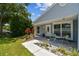 Charming house with a covered front porch and vibrant landscaping, perfect for relaxing outdoors at 2692 Cedarbrooke Dr, Palm Harbor, FL 34684