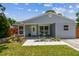 Charming home showcasing a welcoming front porch and vibrant landscaping, creating curb appeal at 2692 Cedarbrooke Dr, Palm Harbor, FL 34684