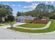 Charming home featuring a well-manicured lawn and mature trees, offering a welcoming curb appeal at 2692 Cedarbrooke Dr, Palm Harbor, FL 34684