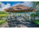 Lakeside gazebo interior with built-in benches offering a serene spot to relax and enjoy calming water views at 2692 Cedarbrooke Dr, Palm Harbor, FL 34684