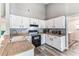 Functional kitchen with white cabinetry, wood-look countertops, and modern appliances at 2692 Cedarbrooke Dr, Palm Harbor, FL 34684