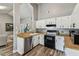 Functional kitchen featuring wood countertops, white cabinets and stainless steel appliances at 2692 Cedarbrooke Dr, Palm Harbor, FL 34684