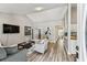 Spacious living room with wood-look flooring, high ceilings and a view of the kitchen and dining area at 2692 Cedarbrooke Dr, Palm Harbor, FL 34684