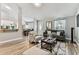 Bright living room featuring wood-look flooring and an open floorplan flowing into the dining area at 2692 Cedarbrooke Dr, Palm Harbor, FL 34684