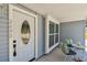 Cozy covered front porch with a seating area to enjoy the outdoors and neighborhood at 2692 Cedarbrooke Dr, Palm Harbor, FL 34684