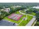 Aerial view of well-maintained tennis courts, showcasing a community amenity with nearby parking and green spaces at 2692 Cedarbrooke Dr, Palm Harbor, FL 34684