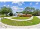 Well-manicured lawn and landscaping accentuates this home's curb appeal, complemented by a curved driveway at 2692 Cedarbrooke Dr, Palm Harbor, FL 34684
