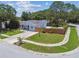 Landscaped front yard and long driveway complement this corner-lot home with a fenced yard at 2692 Cedarbrooke Dr, Palm Harbor, FL 34684