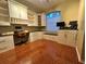 Home office featuring custom built-ins and hardwood floors at 2810 Ravendale Ln, Holiday, FL 34691