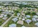 Aerial view of the neighborhood showcasing the home's location near a lake and lush greenery at 304 Fowling Ct # A, Sun City Center, FL 33573