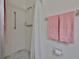 Bright bathroom with white tile shower and pink towels on the towel rack at 304 Fowling Ct # A, Sun City Center, FL 33573