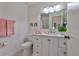 Neat bathroom featuring a vanity with pink accents and a well-lit mirror, creating a clean space at 304 Fowling Ct # A, Sun City Center, FL 33573