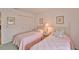Bright bedroom featuring twin beds with coordinated pink quilts and matching floral pillows at 304 Fowling Ct # A, Sun City Center, FL 33573