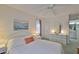 Inviting bedroom with a comfortable bed, soft lighting, and view of the ensuite bath for convenience at 304 Fowling Ct # A, Sun City Center, FL 33573