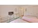 Cozy bedroom featuring twin beds and dresser with TV at 304 Fowling Ct # A, Sun City Center, FL 33573