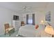 Serene bedroom with neutral tones, a ceiling fan, and a large window that provides natural light at 304 Fowling Ct # A, Sun City Center, FL 33573