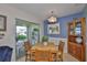 Cozy dining room with wood table and chairs, blue accent wall, and sliding glass doors to the lanai at 304 Fowling Ct # A, Sun City Center, FL 33573