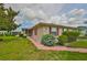 Charming single-story home featuring a well-maintained lawn, colorful flowers, and red shutters at 304 Fowling Ct # A, Sun City Center, FL 33573