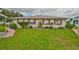 Well-manicured front lawn with green bushes and flowers in front of this tan-sided single story home at 304 Fowling Ct # A, Sun City Center, FL 33573