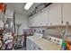 Functional laundry room with washer, dryer, and ample storage in the overhead cabinets at 304 Fowling Ct # A, Sun City Center, FL 33573