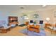 Cozy living room with wood floors, striped sofa, and wooden furnishings for a relaxing ambiance at 304 Fowling Ct # A, Sun City Center, FL 33573