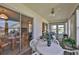 Enclosed patio with a table and seating provides a relaxed outdoor dining experience at 304 Fowling Ct # A, Sun City Center, FL 33573