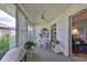 Enclosed patio offers additional living space with a grill and adjacent seating area at 304 Fowling Ct # A, Sun City Center, FL 33573