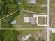 Aerial view showing a single-Gathering house on a large lot with pool, lush trees, and a long driveway at 30703 San An Rd, San Antonio, FL 33576
