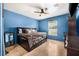 Spacious bedroom with blue walls, tile floors, and a ceiling fan at 30703 San An Rd, San Antonio, FL 33576